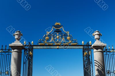 The gate and fence on a blue sky background