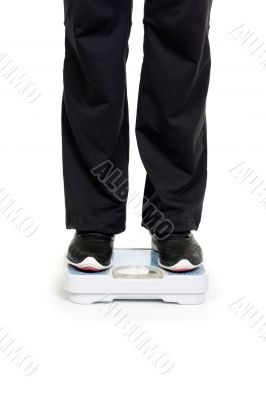 Feet on scales isolated on white background