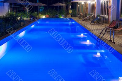 pretty swimming pool in night at a local resort