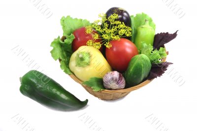 Basket with fruits and vegetables , photographed on a white back