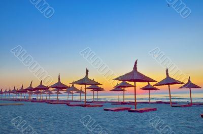 Sunrise under parasol on the beach