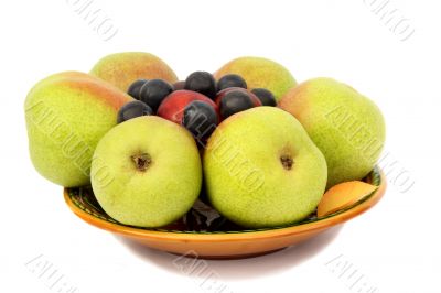 Pears, plums and prunes on the plate on a white background.