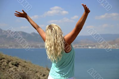 Girl against mountains and the sea