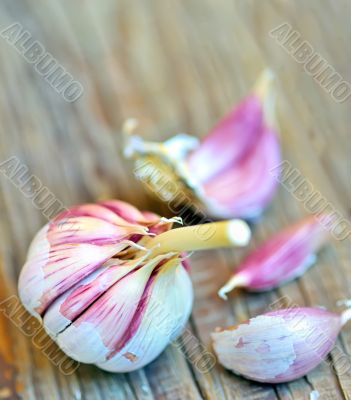 red garlic bulb on old wood