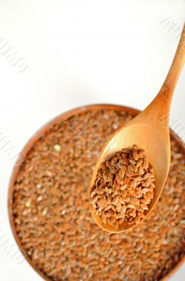 close up of flax seeds and wooden spoon