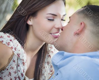 Mixed Race Romantic Couple Kissing in the Park