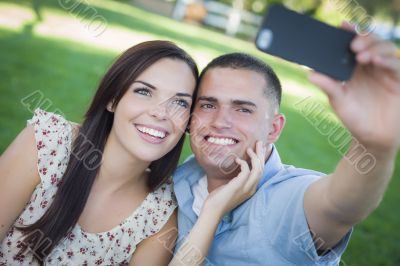 Mixed Race Couple Taking Self Portrait in Park