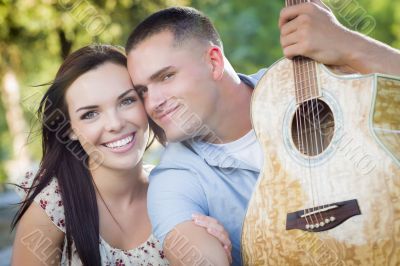 Mixed Race Couple Portrait with Guitar in Park