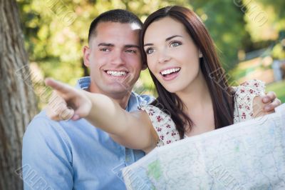 Mixed Race Couple Looking Over Map Outside Together