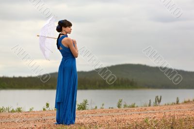 Beautiful dark haired model strolling through the woods.