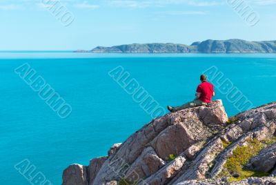 man sitting on a rock