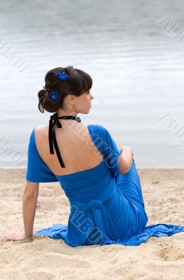 girl in a blue dress sitting