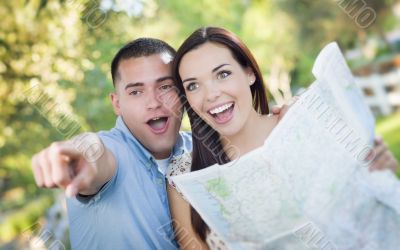Mixed Race Couple Looking Over Map Outside Together