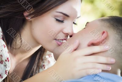 Mixed Race Romantic Couple Kissing in the Park