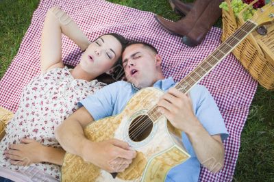 Mixed Race Couple at the Park Playing Guitar and Singing