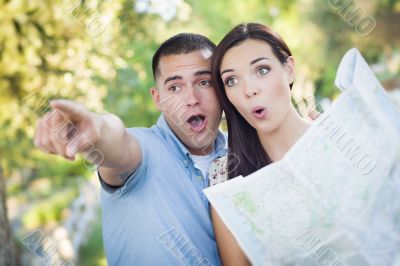 Mixed Race Couple Looking Over Map Outside Together