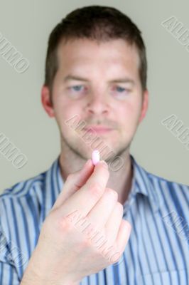 Man holding a Pill