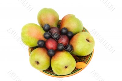 Pears, plums and prunes on the plate on a white background.