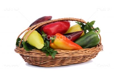 Red, yellow and green pepper in a basket on a white background.