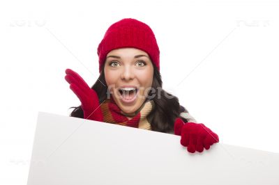 Surprised Girl Wearing Winter Hat and Gloves Holds Blank Sign 