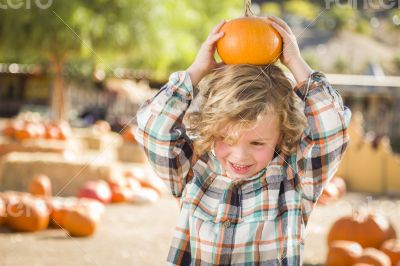 Little Boy Holding His Pumpkin at a Pumpkin Patch