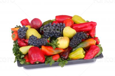 Fruits , pepper and parsley leaves on a plate on a white backgro