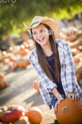 Preteen Girl Playing with a Wheelbarrow at the Pumpkin Patch