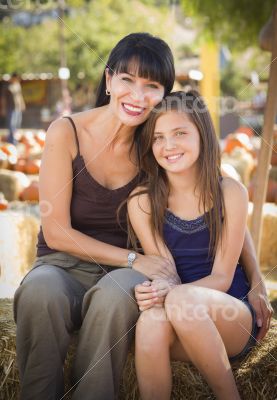 Attractive Mother and Daughter Portrait at the Pumpkin Patch