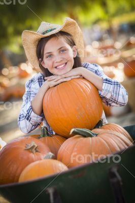 Preteen Girl Playing with a Wheelbarrow at the Pumpkin Patch