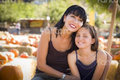 Attractive Mother and Daughter Portrait at the Pumpkin Patch