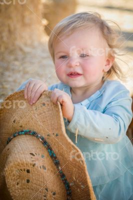Adorable Baby Girl with Cowboy Hat at the Pumpkin Patch
