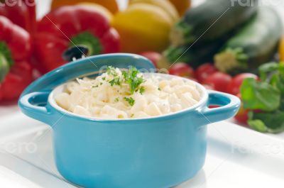 mac and cheese on a blue little clay pot