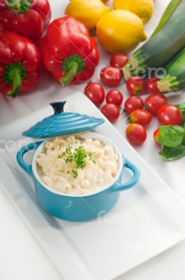 mac and cheese on a blue little clay pot