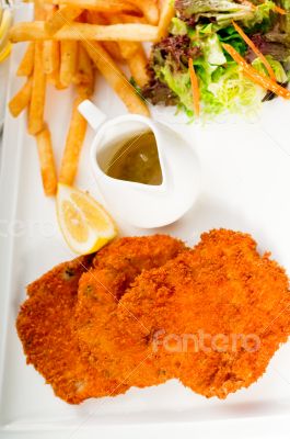 classic Milanese veal cutlets and vegetables