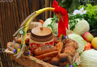 Basket of bread, decorated with ribbons, and vegetables