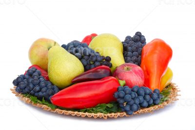 Fruits , pepper and parsley leaves on a plate on a white backgro