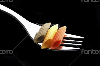 italian penne pasta on a fork