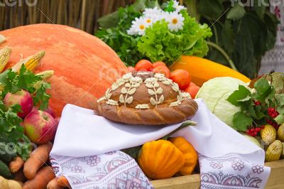 Beautiful cake on a white towel, vegetables, fruits.