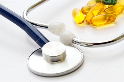 Stethoscope and a lot of colorful pills.
