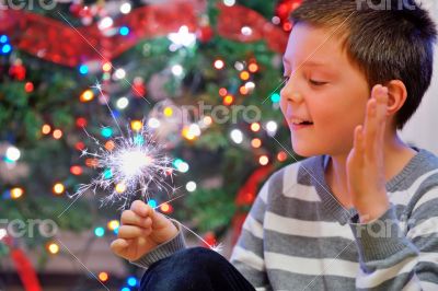 portrait of boy looking at  fire sparks