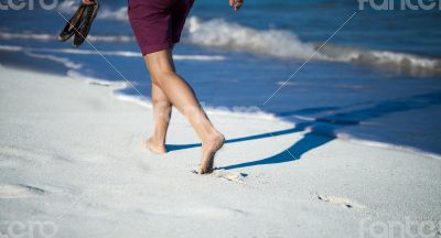 Caribbean cuba woman goes for a walk on the beach in the Caribbean