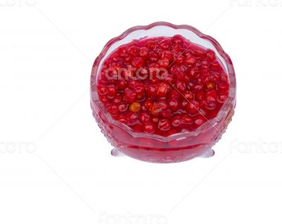 Viburnum berries in syrup on a white background.