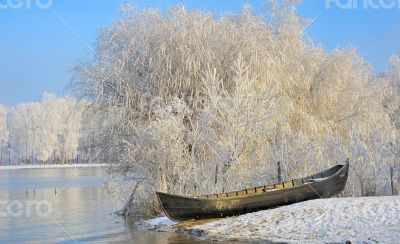 Frosty winter trees and boat
