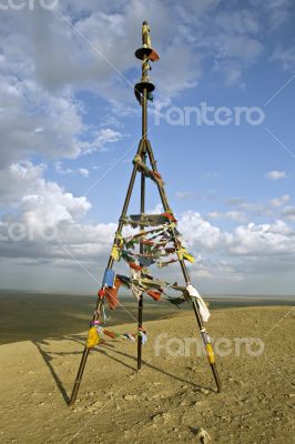 Triangulation mark with buddhist prayer flags