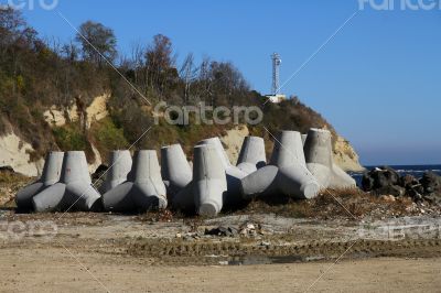 Breakwaters on the boat station. Large gray breakwaters installed at the seaport to reduce the waves.