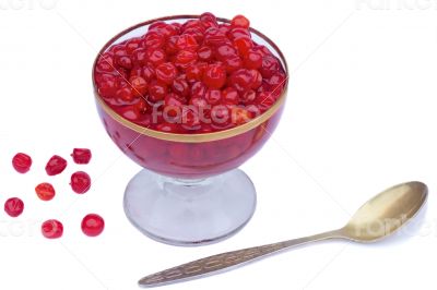 Viburnum berries in syrup on a white background.