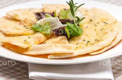 garlic pita bread pizza with salad on top