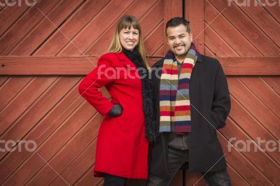 Mixed Race Couple Portrait in Winter Clothing Against Barn Door