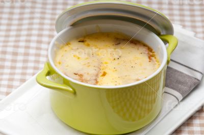 onion soup with melted cheese and bread on top