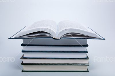 open book on a pile of books